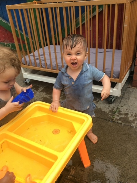 child outdoor playing at nursery